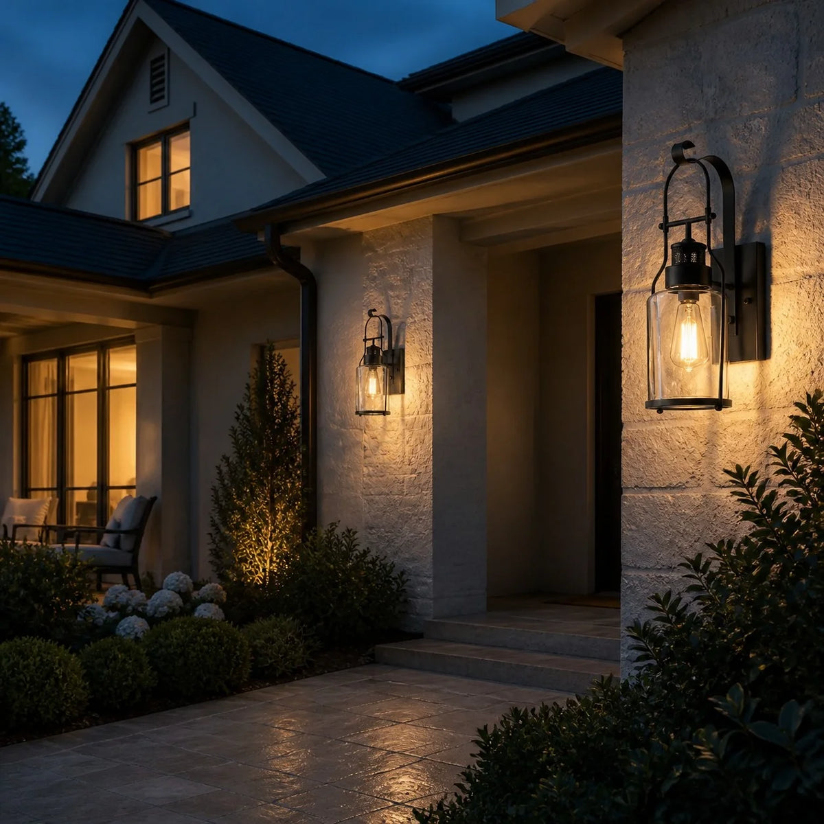 Dakota glass jar wall sconce glowing at night on a home exterior